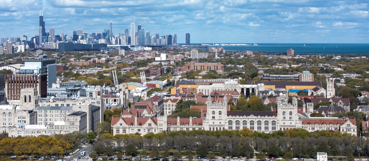 Aerial view of the University of Chicago campus, with downtown Chicago visible in the background.