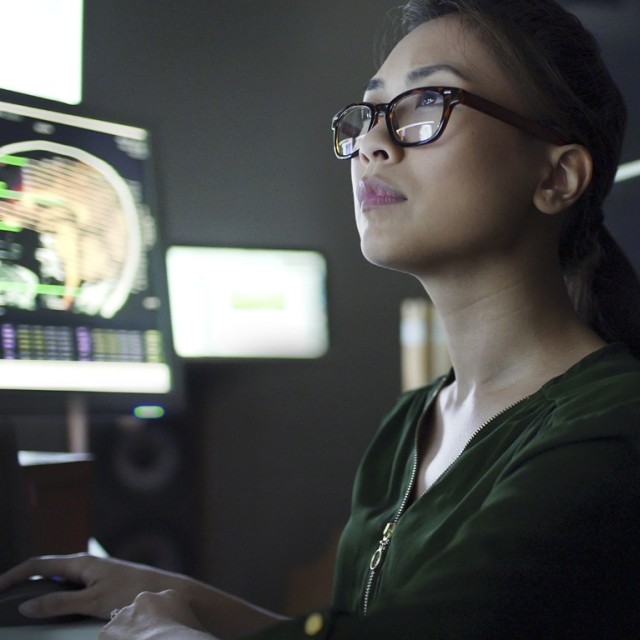 Woman looking at screens
