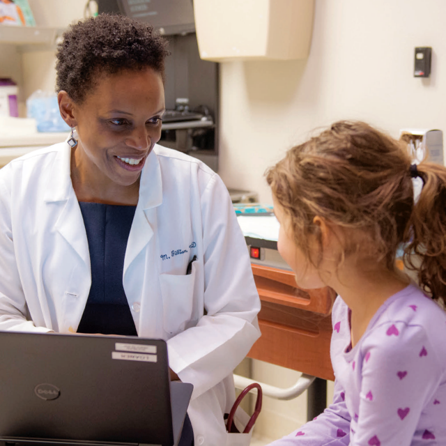 Physician consulting child patient