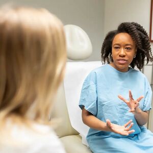 Patient with doctor in exam room