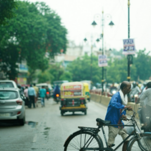 Man pushing a bike across the road